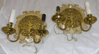 A pair of twin-branch wall sconces in the manner of Gimson,