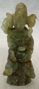 A Chinese carved jadeite figure of female form holding blossom and vase
