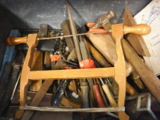A box of various woodworking and other hand tools including, saws, set squares, drill bits, hammers,