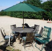A Skyline teak patio set of an octagonal table with six chairs with cushions and parasol,