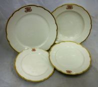 A Berlin KPM part dinner service, the centre white ground within a gilt decorated shaped border,