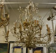 A large gold and cream painted metal multi-branch electrolier of scrolling foliate design with