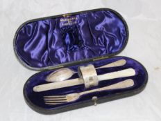 An Edwardian silver cased Christening set comprising knife, fork,
