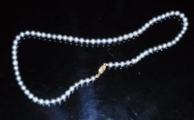 A Japanese Akoa single strand pearl necklace