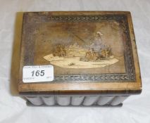 A Sorrento ware puzzle box in the form of book spines, the top with inlaid scene of couple fishing,