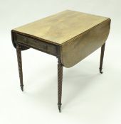A Regency mahogany Pembroke table, the plain top over two end drawers with lion mask ring handles,