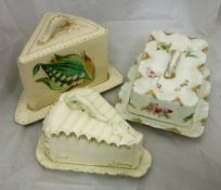 A collection of five cream pottery cheese domes in various designs and makers,
