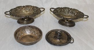 A pair of late Victorian silver twin handled bonbon dishes with leaf and foliate decoration
