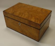 A 19th Century satinwood tea caddy with two sections to the interior,
