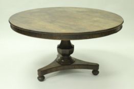 A 19th Century rosewood tilt-top breakfast table with plain frieze over a faceted baluster support
