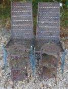 A pair of modern wrought iron and caned garden chairs,