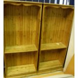 A pair of modern pine open bookcases with adjustable shelving