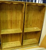 A pair of modern pine open bookcases with adjustable shelving