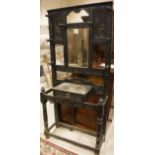 A Victorian gothic revival stained oak and carved mirrored back hall stand