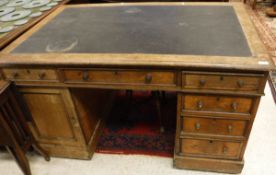 A Victorian oak partners desk with three frieze drawers opposite three further frieze drawers on