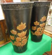 Two painted metal waste paper bins decorated with flowers