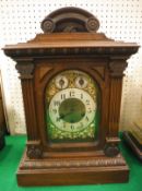 A late 19th Century German walnut cased mantle clock of architectural form,