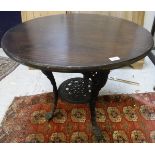 A cast iron pub table with replacement mahogany top