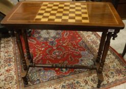 A mahogany and satinwood inlaid games table with twin end pillar supports united by a turned