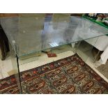 A glass three section desk on end pedestal supports