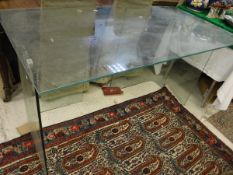 A glass three section desk on end pedestal supports
