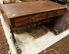 A circa 1900 mahogany two drawer library table on end pillar supports to scroll feet and castors