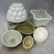 A collection of fourteen stoneware jelly moulds to include Mintons example with wheatsheaf design,