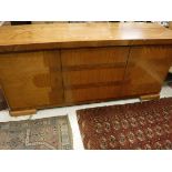A 20th Century sideboard with pull-out marble slide above cupboard doors to bracket feet
