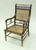 An Ernest William Godwin designed walnut framed salon chair with turned and ringed top rail above