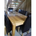 A modern oak extending dining table with two extra leaves and set of eight leather covered high
