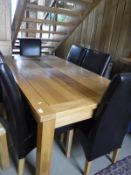A modern oak extending dining table with two extra leaves and set of eight leather covered high
