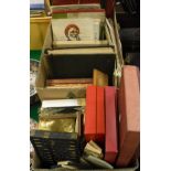 A box containing various games and toys including Monopoly, Lotto, Scrabble,