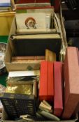 A box containing various games and toys including Monopoly, Lotto, Scrabble,