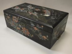 A lacquered and mother of pearl inlaid writing slope with exotic bird amongst foliage decoration