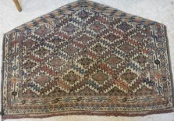 A Bokhara Juval rug, the main panel set with repeating medallions on a pink,