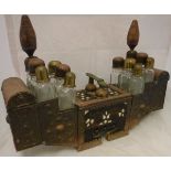 A Turkish copper shoe shining kit with twelve assorted glass bottles and assorted compartments,