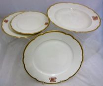 A Berlin KPM part dinner service, the centre white ground within a gilt decorated shaped border,