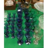 A selection of blue coloured wine glasses, together with a selection of blue sherry glasses,