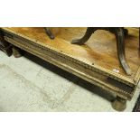 An Indian hardwood coffee table with sliding compartment top raised on bell shaped legs