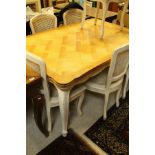 A modern draw leaf dining table in the Continental manner,