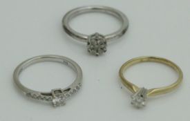 An 18 carat white gold diamond dress ring, together with a 14 carat gold ring set with a 0.