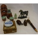A boxed Saki set, a Buddha wall mask, a carved stone figure of a horse, a pipe, a Chinese seal,