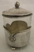 An Arts & Crafts silver mounted glass preserve pot with rose head motifs to the body,