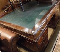 An early 20th Century oak partners desk,