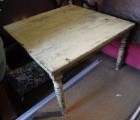 A modern yellow painted pine farmhouse style kitchen table in the Victorian manner