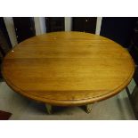 A modern chalon breakfast table with polished circular top and painted base