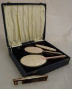 A mid 20th Century silver and enamel four part dressing table vanity set, to include two brushes,