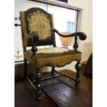 An oak framed elbow chair in the 18th Century Flemish manner with upholstered needlework seat and