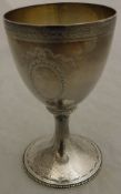 A modern silver goblet in the Georgian style with engraved banded decoration on a circular foot