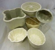 A collection of fourteen stoneware jelly moulds to include Mintons example with wheatsheaf design,